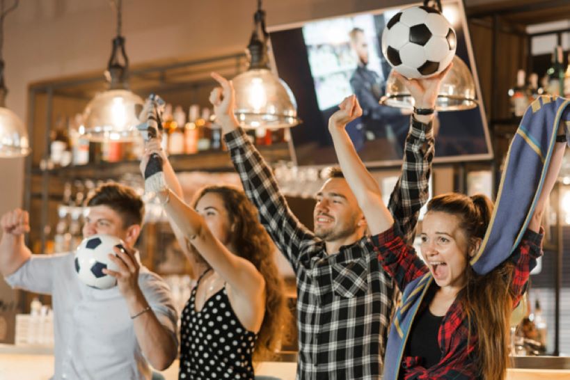 friends watching sport in bar