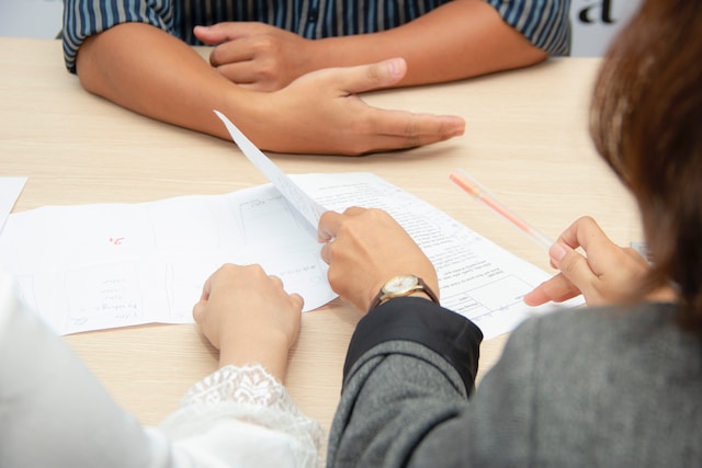 person holding documents while in a meeting